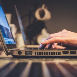 Man typing with a laptop